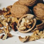 “뇌를 젊게, 마음을 건강하게: 일상 속 뇌건강을 위한 실천법” A pile of whole and shelled walnuts